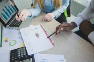 Two people analyzing charts